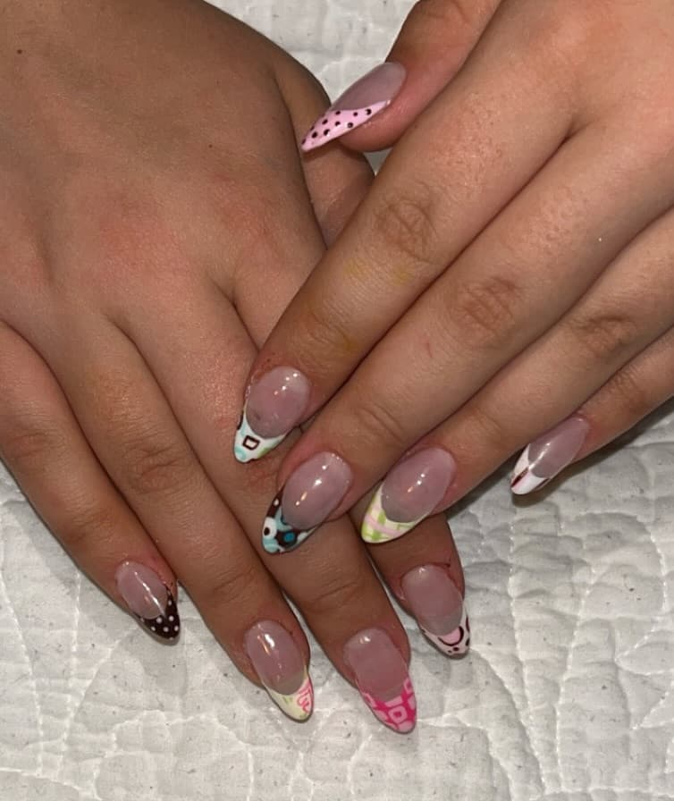 Long almond nails in sheer mauve with mismatched retro French tips of polka dots, plaid and pink geometric patterns